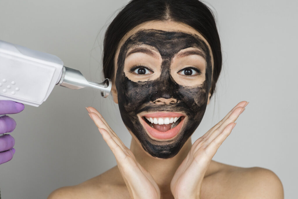 Carbon Facial asian,woman,with,black,mask,on,face,with,surprised,emotionon,